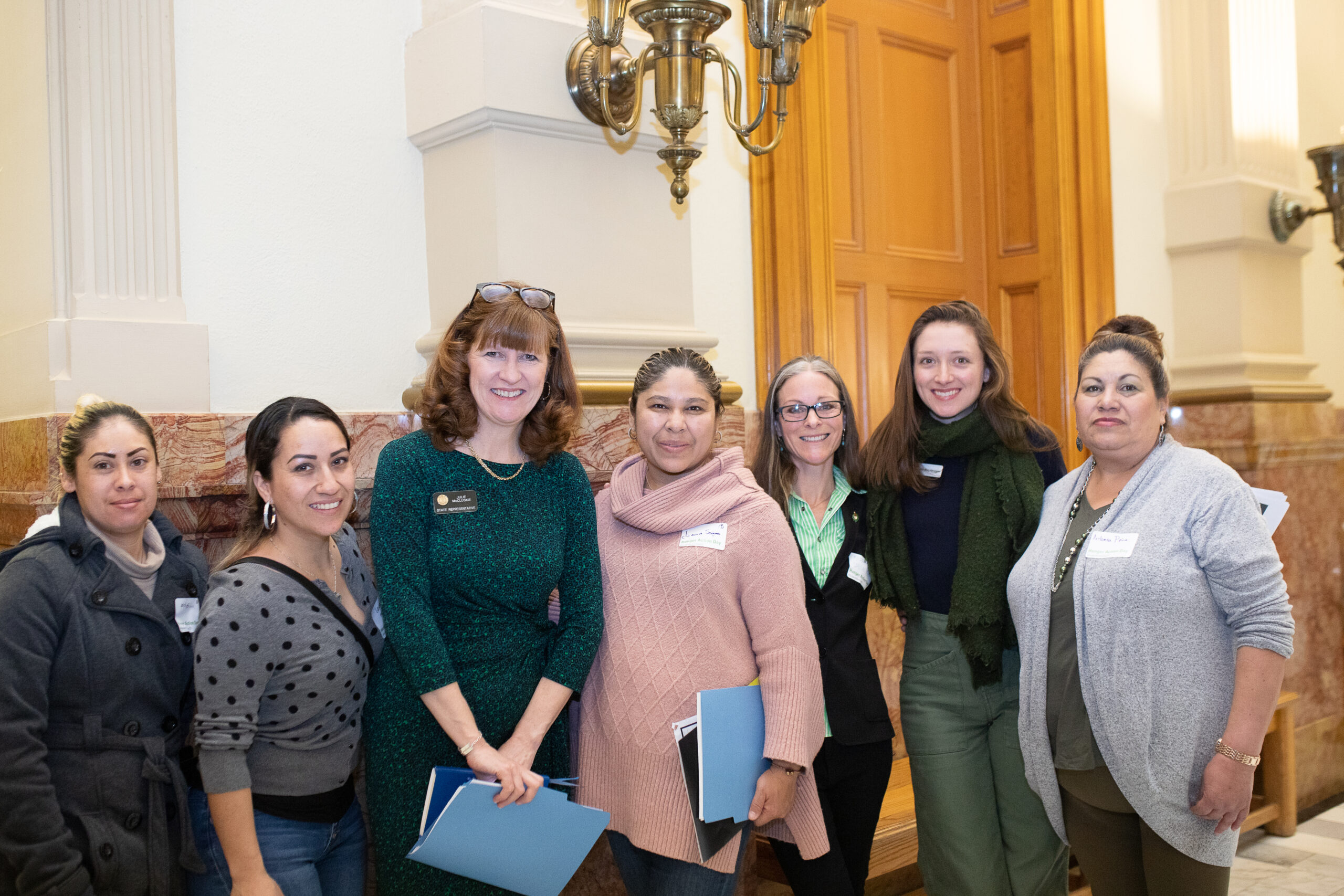 six women standing with legislator at Colorado state capital